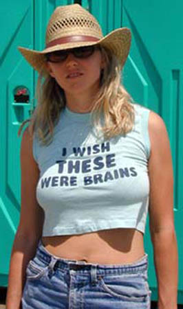 1968 Ford Mustang - A woman poses for a photo in front of a portable toilet, wearing a hat and a shirt with a humorous message.