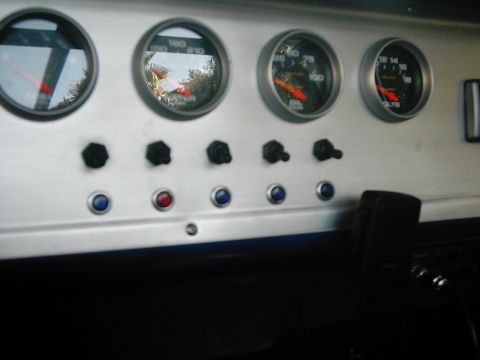 1978 Ford Bronco - Aftermarket gauges and switches installed on a custom dashboard panel.