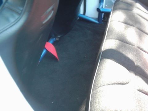 1978 Ford Bronco - Interior shot showing a blue roll cage and a red pull strap on the floor.