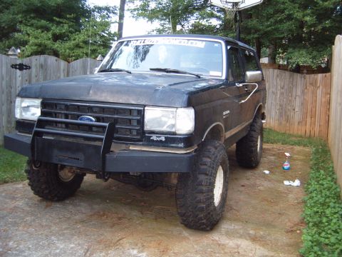 1988 Ford Bronco - This lifted Ford Bronco has a custom front bumper and off-road tires.
