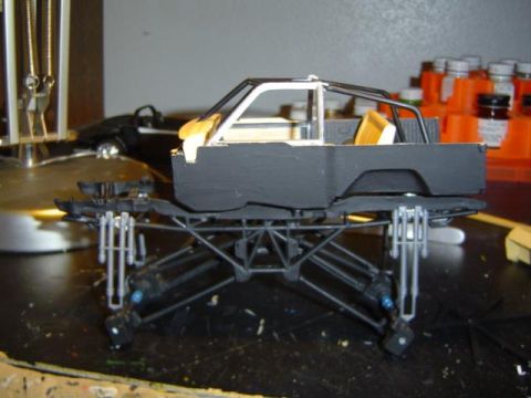 1979 Ford Bronco - Model truck chassis and body under construction, with paint bottles visible in the background.