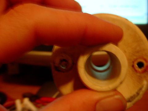 1973 Ford Ranchero - A beige automotive part with a central hole is held by fingers, with 'SUPERMOTORS' visible at the bottom right.