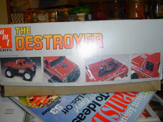 Box art for AMT Ertl model kit "The Destroyer" showing monster trucks and a motorcycle