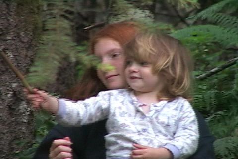 1996 Ford Bronco - Two children explore a wooded area, with one pointing with a stick.