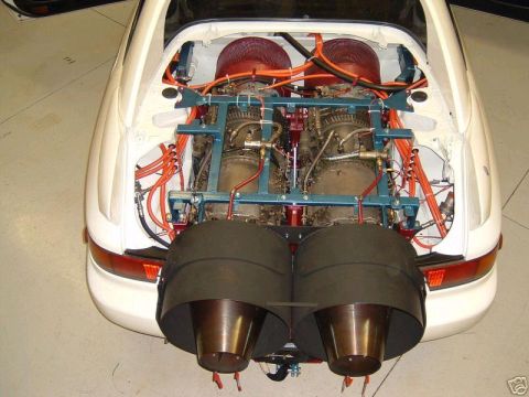 1988 Ford Bronco - A white car modified with twin jet engines in the rear, revealing complex plumbing and exhaust systems.