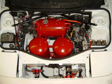 1988 Ford Bronco - Engine bay features prominent red tanks and complex plumbing, with a Supermotors.net watermark.