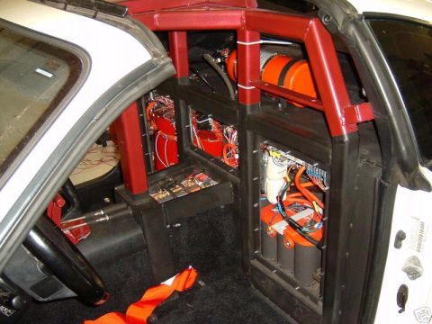 1988 Ford Bronco - The interior of this vehicle has been heavily modified with a roll cage and extensive electrical components visible.