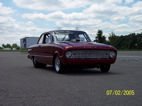 1960 Ford Falcon - A 1960 Ford Falcon sedan is shown from the front-three-quarter view on a cloudy day.
