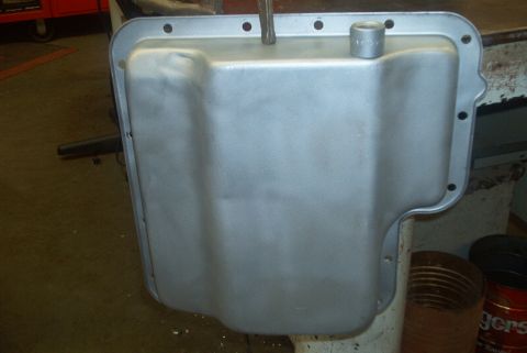 1983 Ford Bronco - Oil pan with bolt holes and drain plug fitting, likely for a vehicle transmission.
