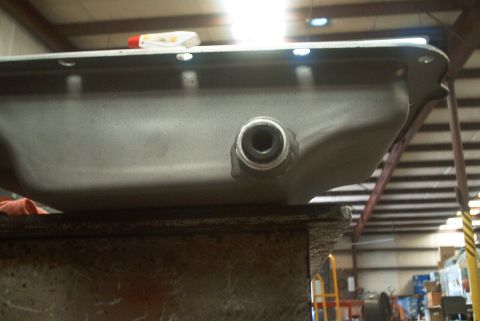 1983 Ford Bronco - Oil pan with drain plug opening, likely for a vehicle engine.