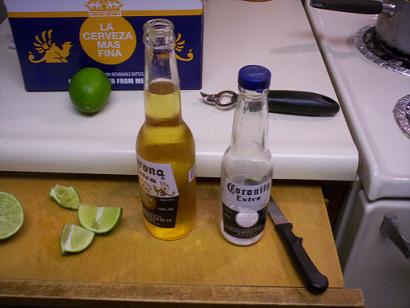 1970 Mercury Cougar - Corona beer bottles and limes are prepared on a cutting board next to a kitchen stove.