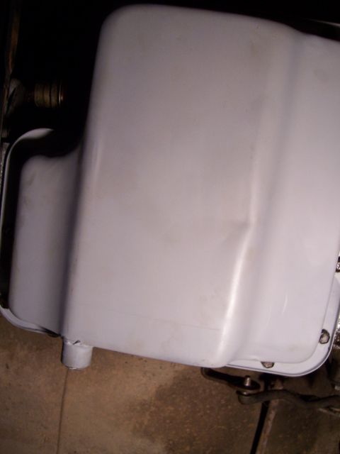 1983 Ford Bronco - Close-up of a vehicle's oil pan, showing the drain plug area.