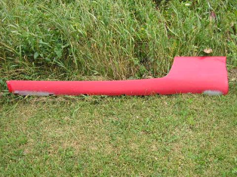 1994 Ford Probe - A red car door sill trim piece lies on the grass, with a Supermotors.net watermark visible.