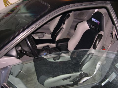 1997 Ford Probe - The interior of a car features aftermarket racing seats with "Tenzo R" branding visible on one.