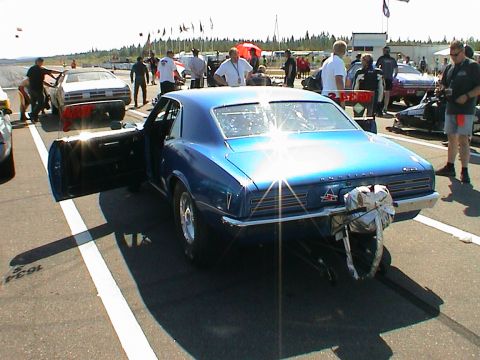 1979 Ford Bronco - A blue 1967 Pontiac Firebird drag car is parked on a track with its door open and a parachute attached to the rear bumper.