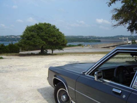 1988 Ford LTD Crown Victoria - 1988 Ford Crown Victoria LTD parked with a scenic lake and bridge view.
