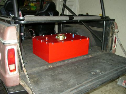 1995 Ford Bronco - Rear view of a 1978 Ford Bronco showing a custom red fuel tank in the cargo area.