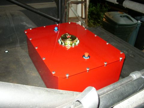 1995 Ford Bronco - A red fuel cell with a brass cap and blue and orange fittings is visible in the cargo area of a vehicle.