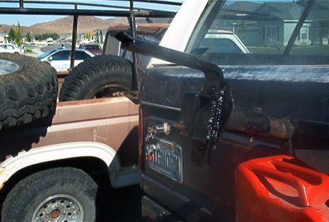 1986 Ford Bronco - I cut a piece of 2x4" square tube and welded it to the stock tire carrier part. I then drilled the square tube and welded a 1/2 ton lug fro…