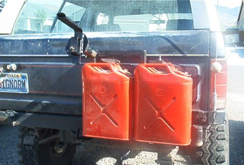 1986 Ford Bronco - This SUV is equipped with a rear-mounted rack holding two red jerrycans.
