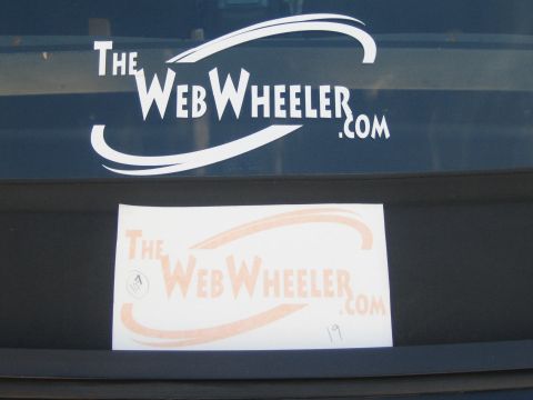1990 Ford Bronco - white window decal and an orange paper logo for 'TheWebWheeler.com' shown on a dark vehicle.