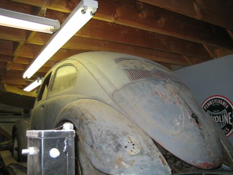 1968 Ford Mustang - A vintage Volkswagen Beetle sits in a garage, showing signs of age and disrepair.