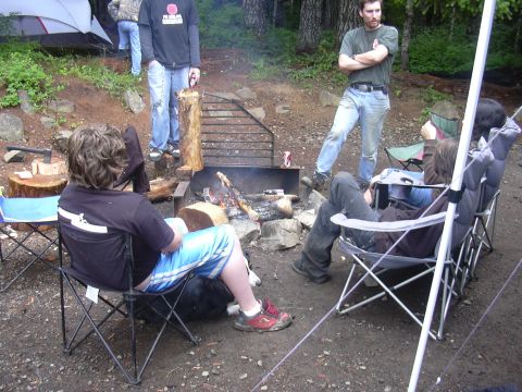 1991 Ford Bronco - Friends enjoy a campfire gathering in a wooded area.