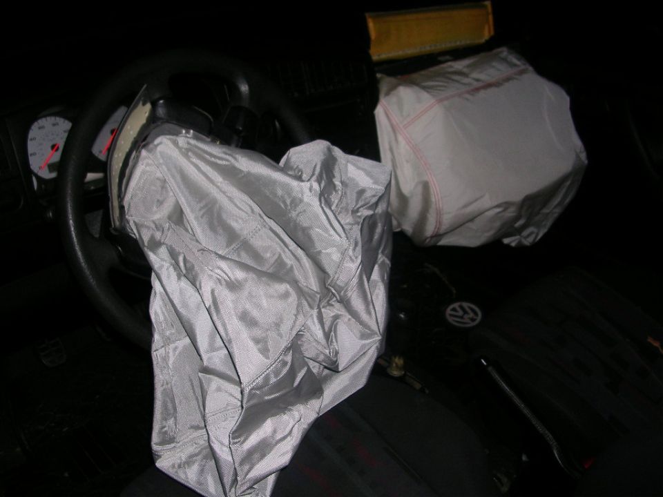 Deployed driver and passenger airbags inside a Volkswagen interior