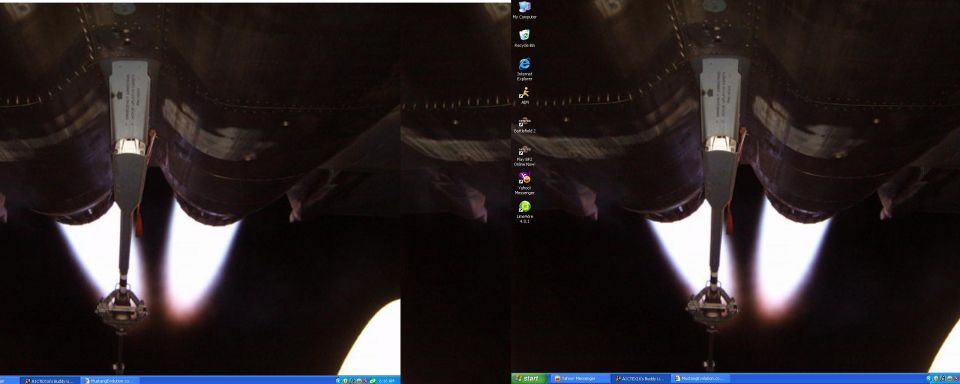 Computer desktop wallpaper showing two rocket engine nozzles with exhaust flames