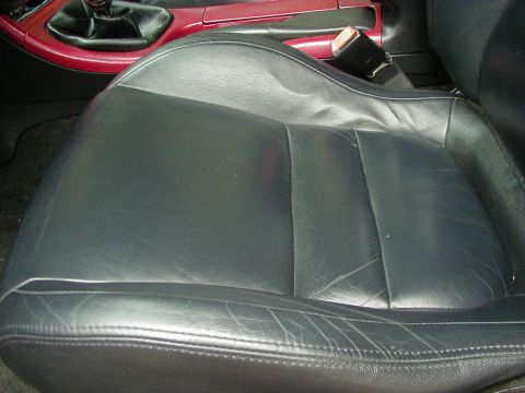 1994 Ford Probe - Close-up of a car's interior, focusing on the driver's seat and part of the center console.