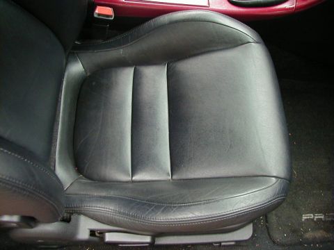 1994 Ford Probe - Interior shot of a car seat, showing the texture and stitching of the black leather upholstery.