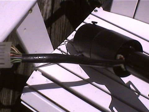 1978 Ford Bronco - Close-up of a vehicle's steering column wiring harness, showing the connector and taped wires.