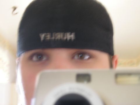 1990 Ford Probe - A person is taking a selfie with a digital camera, wearing a black hat with the Hurley logo.