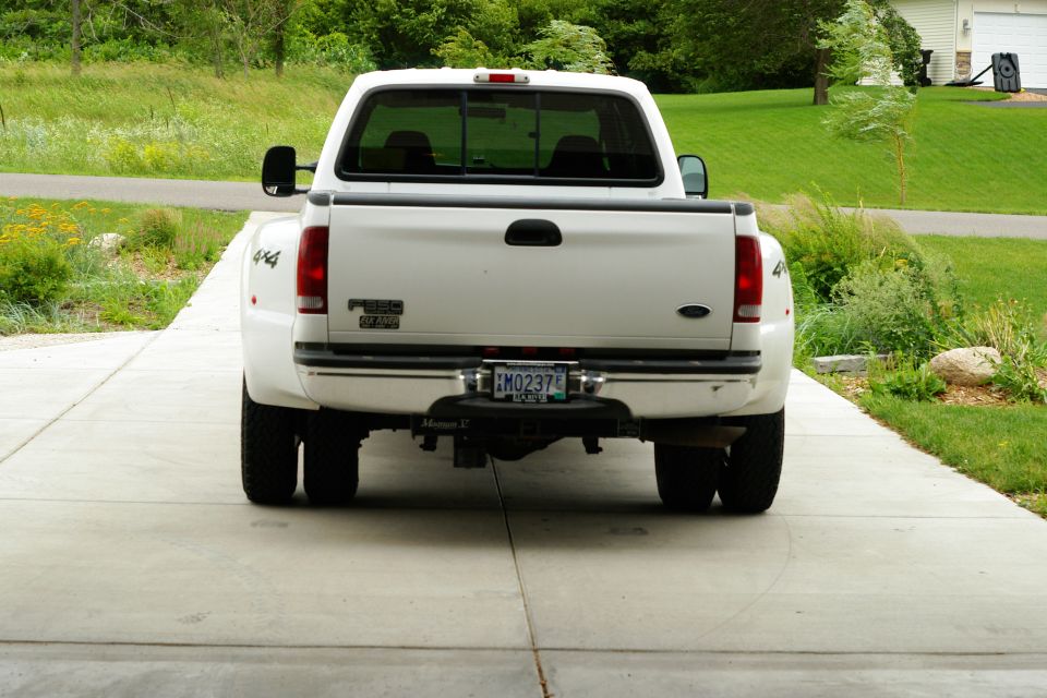 Rear view of a white 2002 Ford F-350 Super Duty pickup truck with dual rear wheels