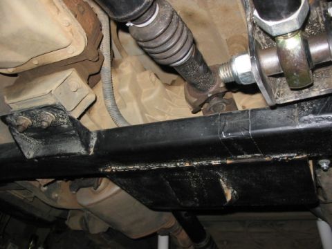 1995 Ford Bronco - Undercarriage view shows the driveshaft and exhaust system of a vehicle.