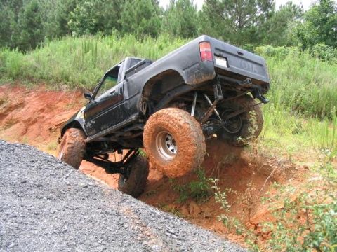 1986 Ford F-150 - This modified Toyota pickup truck navigates a challenging off-road course.