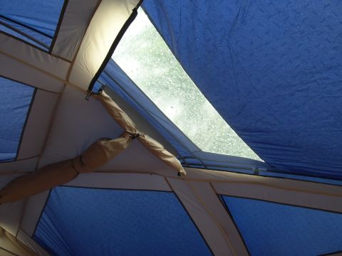 1997 Ford Probe - View from inside a tent, showing the interior structure and a rain-streaked window. A website logo is visible.