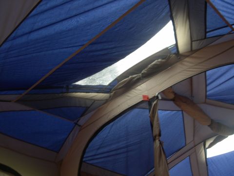 1997 Ford Probe - Interior view of a tent with multiple fabric panels and poles, illuminated by a skylight.