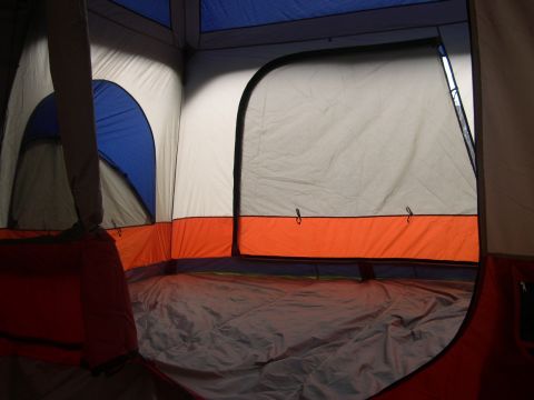 1997 Ford Probe - The interior of a large tent is shown, multiple sleeping areas and a blue and orange color scheme.