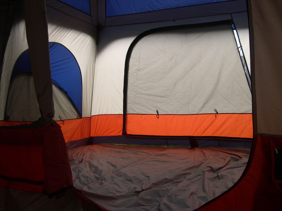 Interior of a large tent with blue and orange accents
