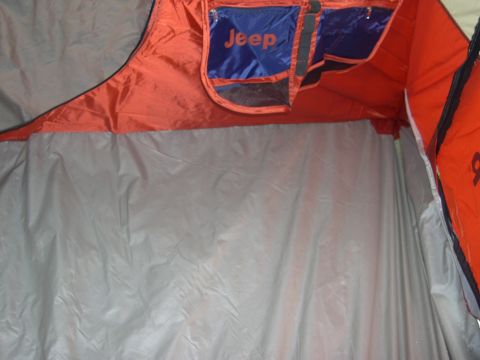 1997 Ford Probe - Interior view of a tent with "Jeep" logo pockets visible on the orange fabric.