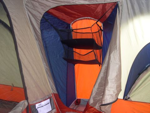 1997 Ford Probe - The interior of a tent is shown, multiple fabric colors and a hanging organizer with shelves.