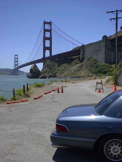 1985 Mercury Grand Marquis - Rear view of a blue sedan parked near the Golden Gate Bridge, with a Supermotors.net watermark visible.