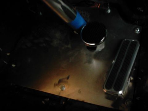 1978 Ford Bronco - Close-up of vehicle interior floor with brake pedal and shifter knob visible.