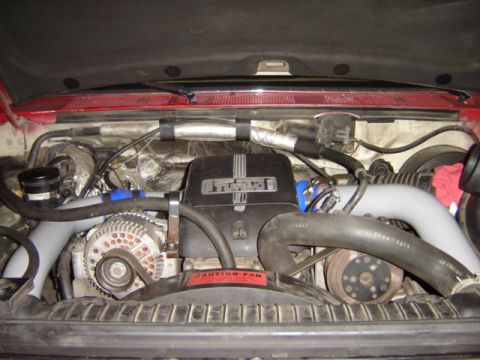 1992 Ford Bronco - The engine bay shows a turbocharger and alternator, with a 'Caution: Fan' sticker visible.