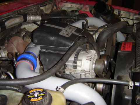 1992 Ford Bronco - Close-up view of an engine bay, highlighting the turbocharger and associated components.
