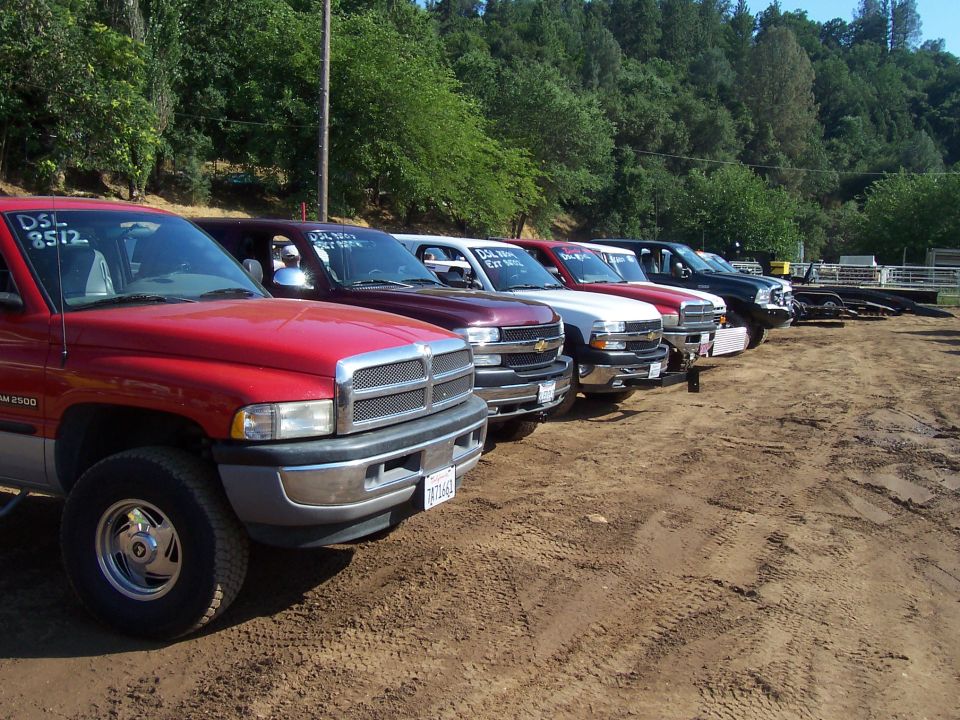 Red 1994 Dodge Ram 2500 pickup truck, front view, parked on dirt lot