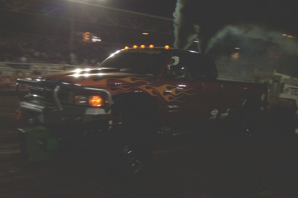 Dodge Ram pickup with flame decals and smoke coming from exhaust