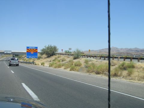 1993 Ford Taurus - Driving past the Arizona state welcome sign on a clear day with mountains in the distance.