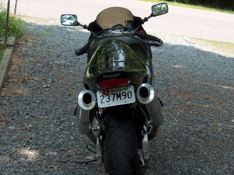 2002 Suzuki TL1000R - A black motorcycle is viewed from the rear, displaying its dual exhaust and license plate.